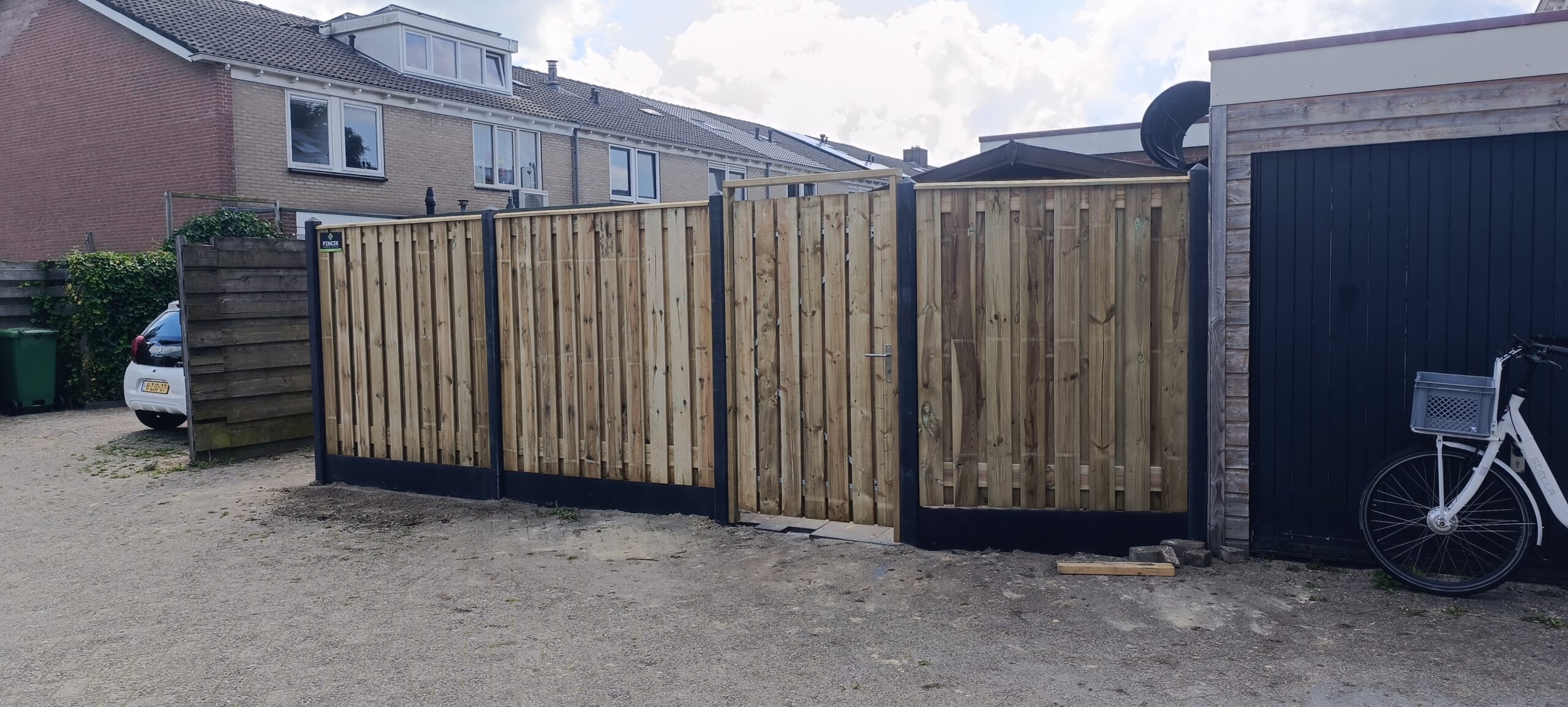 Houten schutting met poort in een woonstraat